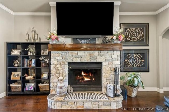 3526 Evans Ave, Mannford, OK 74044 - detailed view of wood finished floors, baseboards, arched walkways, ornamental molding, and a stone fireplace