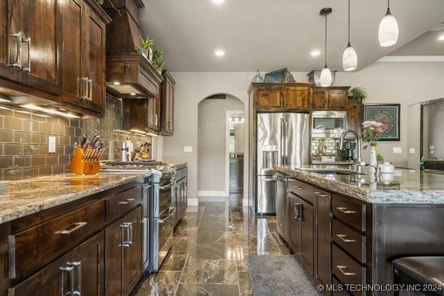 3526 Evans Ave, Mannford, OK 74044 - kitchen with stainless steel appliances, arched walkways, custom range hood, a sink, and dark marble finish flooring