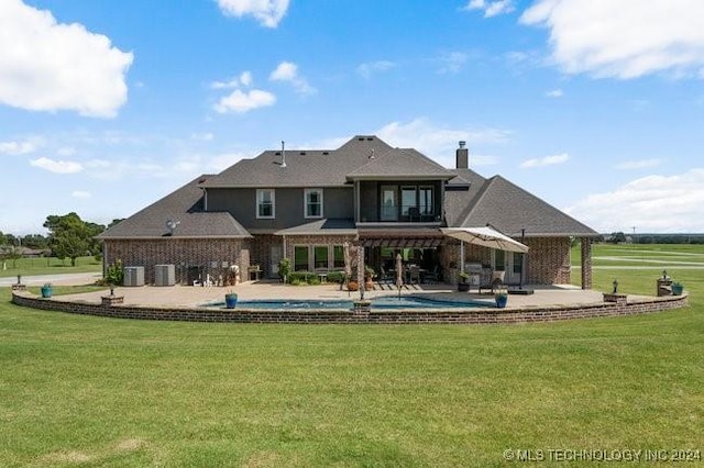 3526 Evans Ave, Mannford, OK 74044 - rear view of house with an outdoor pool, a patio, a yard, a chimney, and central AC unit