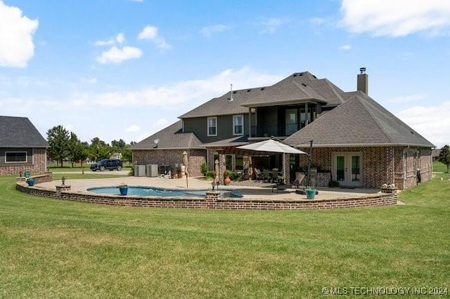 3526 Evans Ave, Mannford, OK 74044 - rear view of property featuring a chimney, a yard, a patio, and french doors