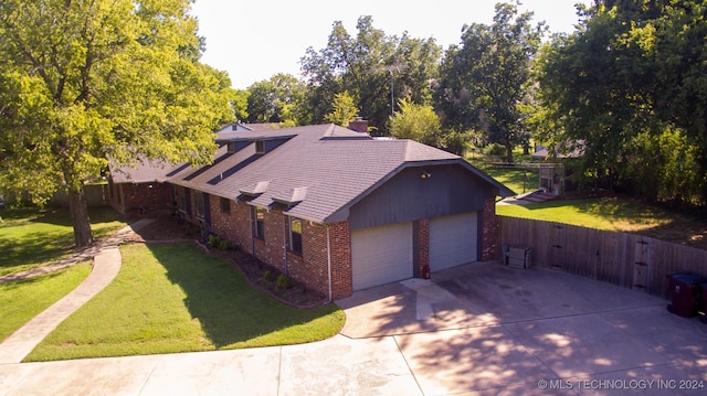 view of front of house with a garage and a front lawn