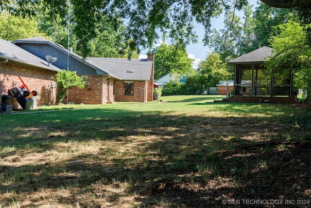 view of yard featuring a sunroom