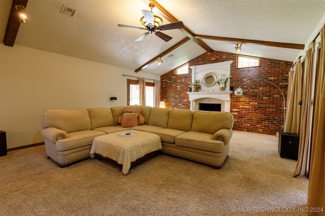 living room with carpet flooring, vaulted ceiling with beams, a large fireplace, ceiling fan, and brick wall