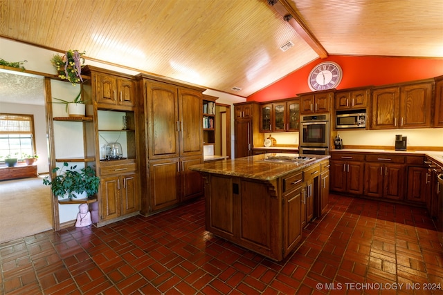 kitchen with appliances with stainless steel finishes, wood ceiling, lofted ceiling with beams, a center island, and dark stone counters