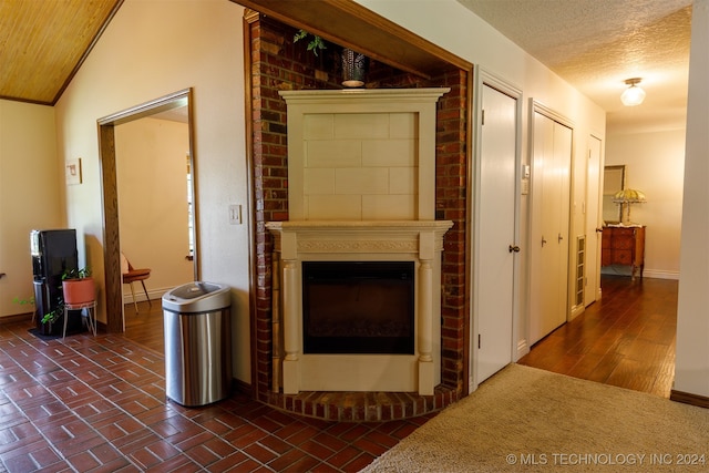 hallway with a textured ceiling and vaulted ceiling