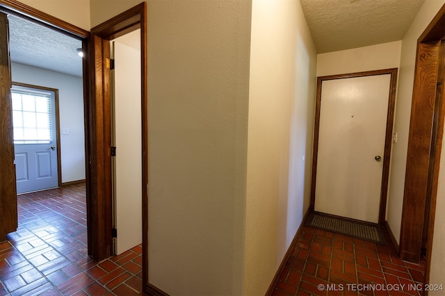 corridor with a textured ceiling