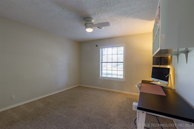 unfurnished office with a textured ceiling, carpet flooring, and ceiling fan