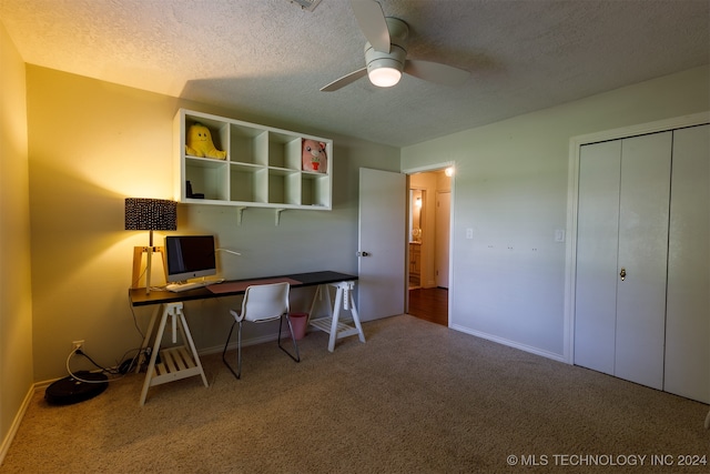 unfurnished office featuring carpet floors, a textured ceiling, and ceiling fan