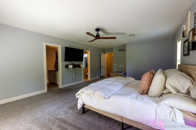 bedroom with connected bathroom, a textured ceiling, carpet flooring, ceiling fan, and a walk in closet