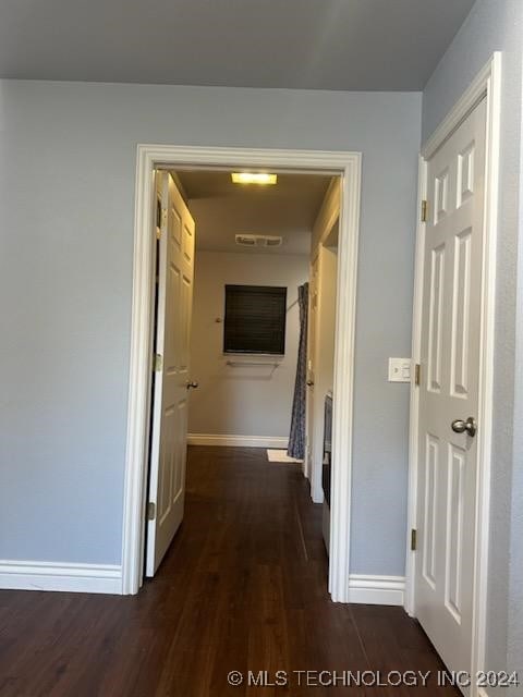 corridor with dark hardwood / wood-style floors