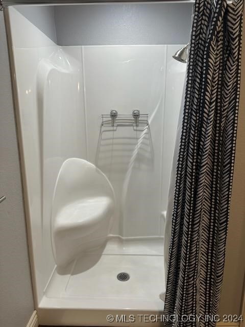 bathroom with a shower with curtain