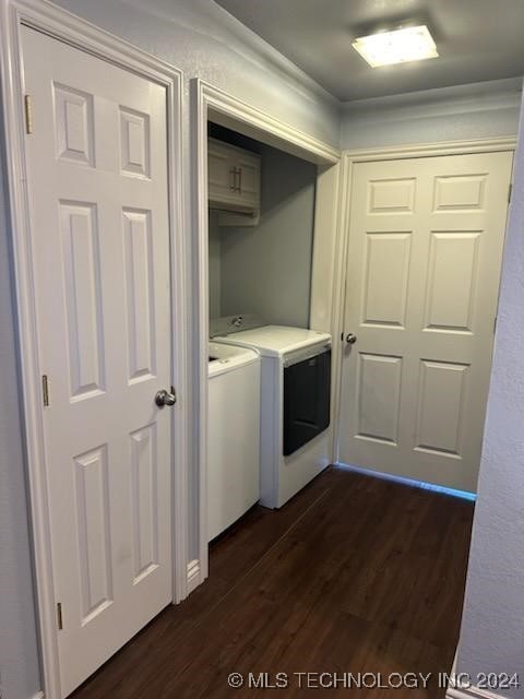 laundry room with separate washer and dryer and dark hardwood / wood-style flooring