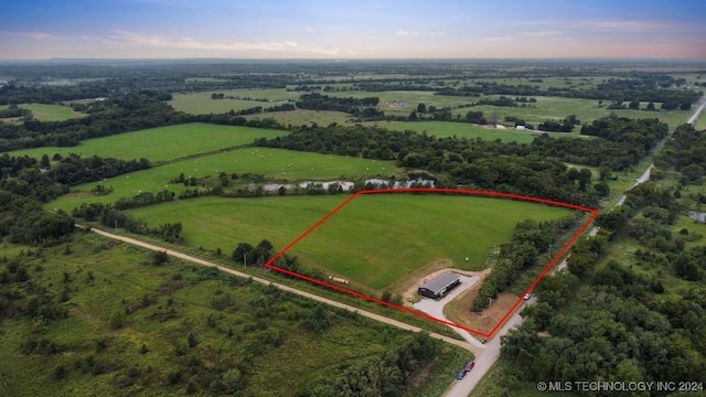 aerial view at dusk featuring a rural view