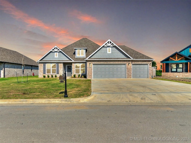 craftsman inspired home with a lawn and a garage