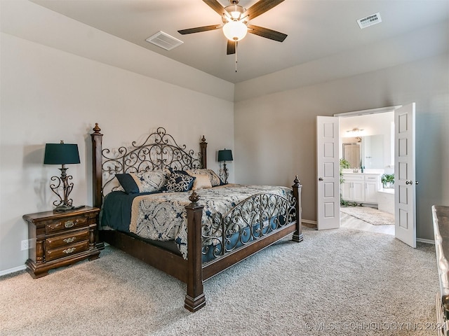 carpeted bedroom featuring visible vents, connected bathroom, and baseboards