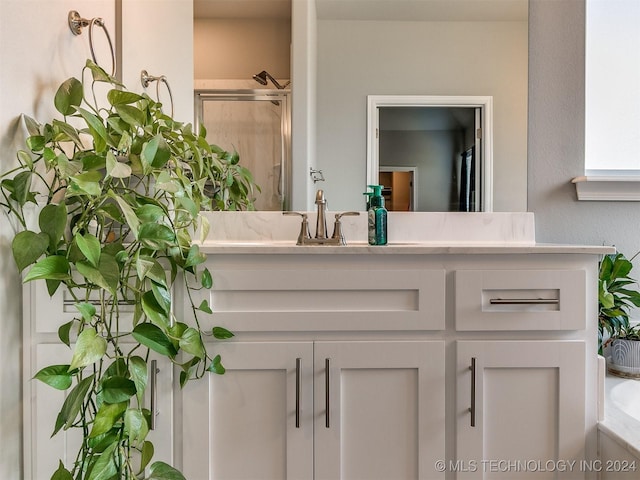 full bath featuring a stall shower, vanity, and a bath