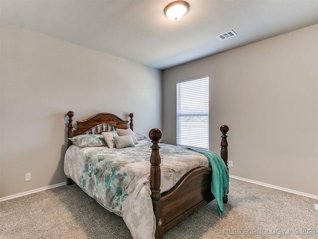 bedroom with carpet floors, visible vents, and baseboards