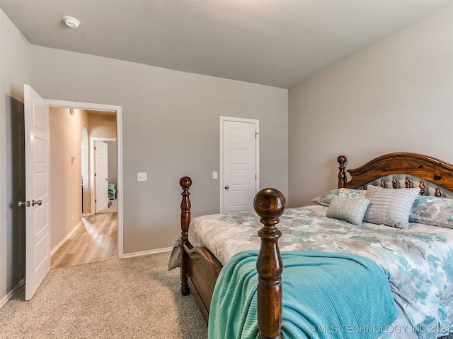 bedroom featuring light colored carpet