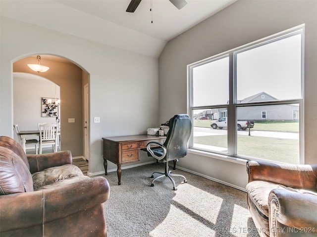 home office with vaulted ceiling, ceiling fan, and carpet floors