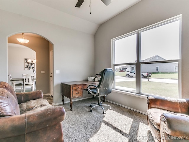 carpeted office with arched walkways, ceiling fan, lofted ceiling, and baseboards