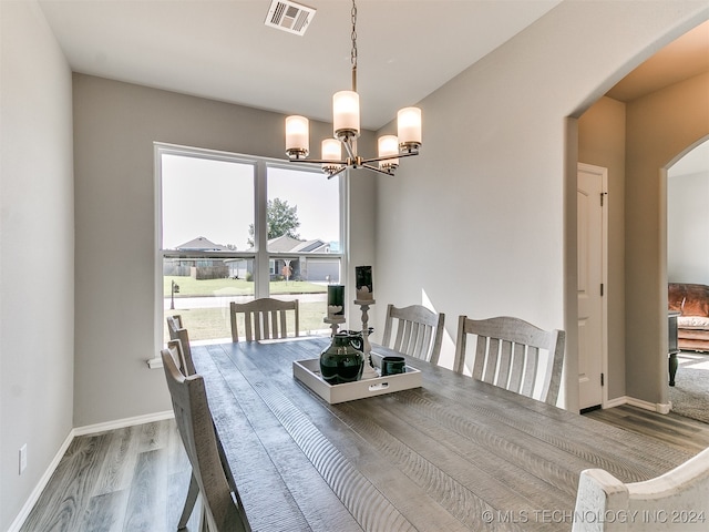 dining space featuring an inviting chandelier and hardwood / wood-style floors