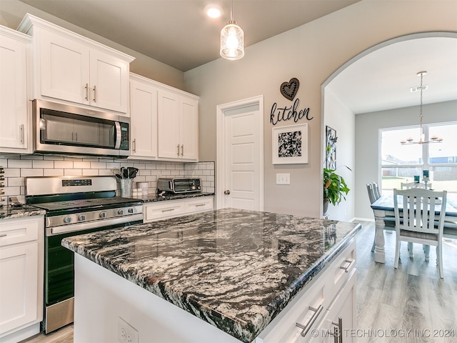 kitchen with white cabinets, a center island, and stainless steel appliances