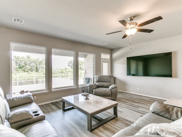 living room featuring ceiling fan and hardwood / wood-style flooring