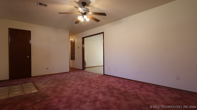 carpeted empty room featuring ceiling fan