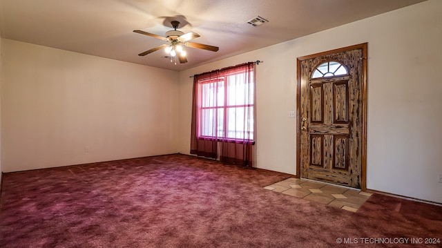 carpeted foyer with ceiling fan