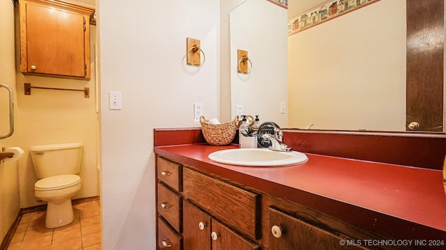 bathroom with vanity, toilet, and tile patterned flooring