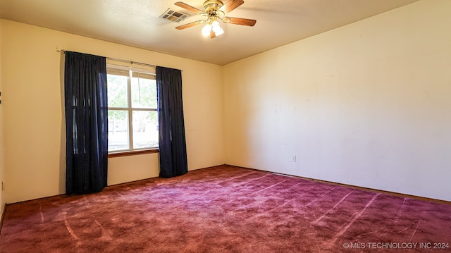 carpeted spare room with ceiling fan