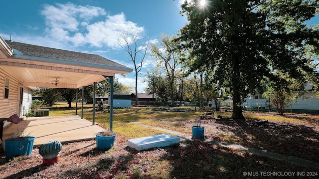 view of yard featuring ceiling fan and a patio