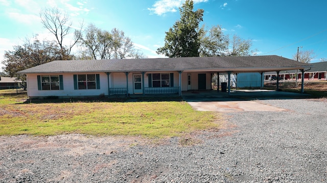 ranch-style home with a carport and a front lawn