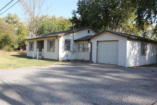 single story home with a front yard and a garage