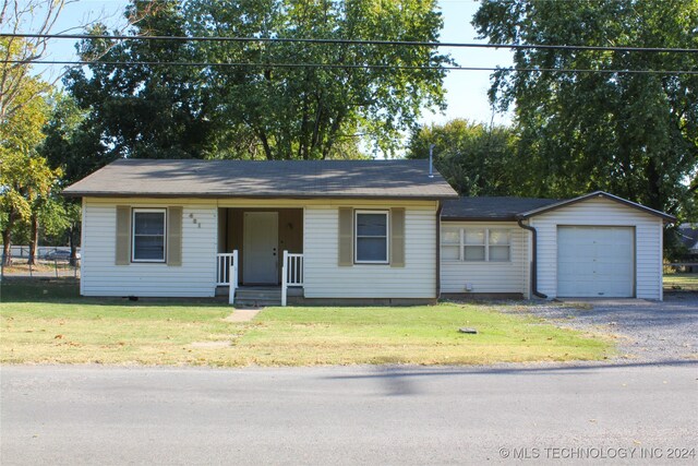 ranch-style house featuring a front yard, a porch, and a garage