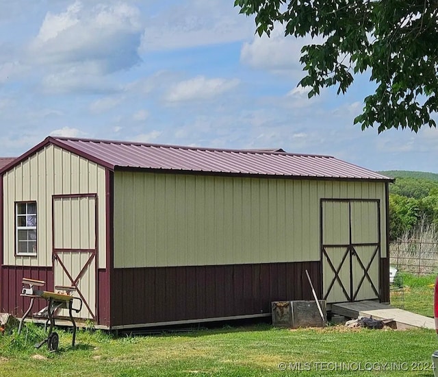 view of outbuilding with a yard