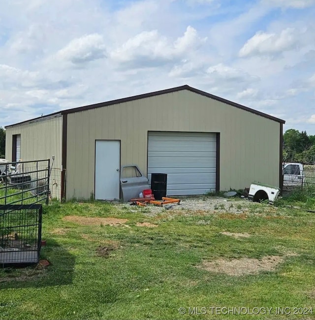 view of outbuilding with a garage and a lawn