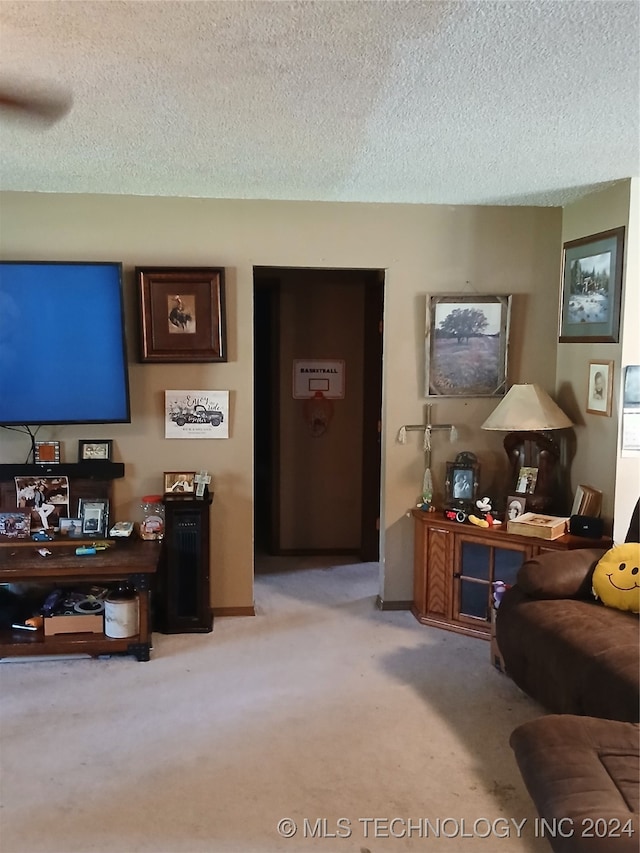 carpeted living room featuring a textured ceiling