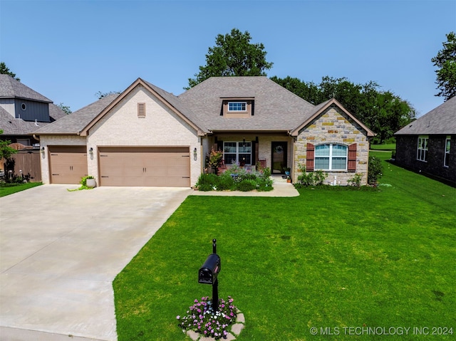 craftsman house featuring a front yard and a garage