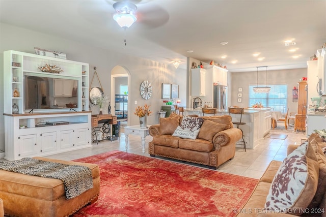 tiled living room with ceiling fan