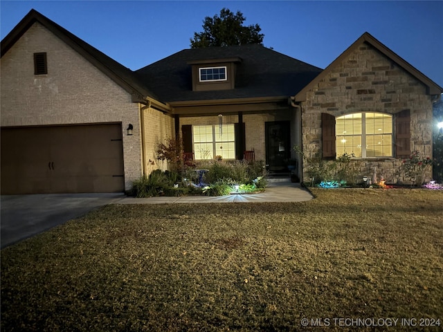 view of front of property with a garage and a front yard