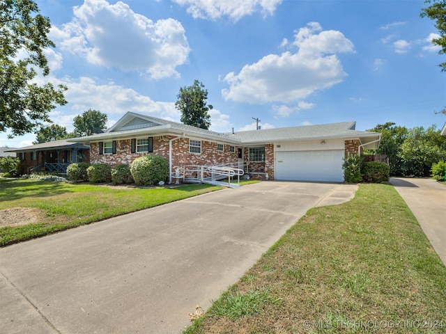 ranch-style home featuring a garage and a front lawn