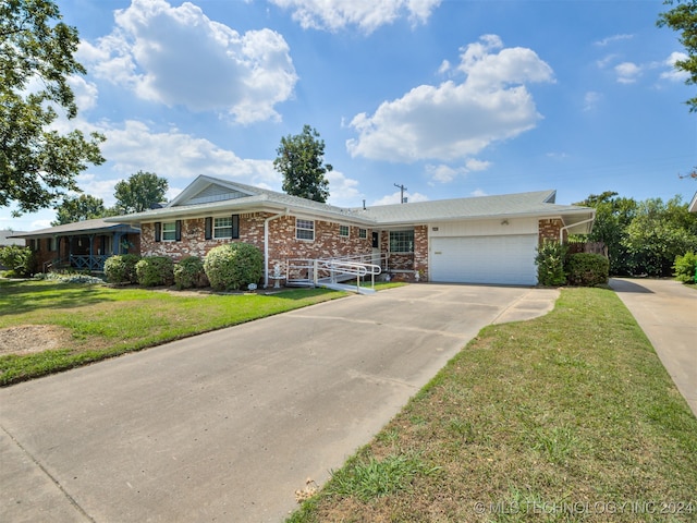 ranch-style house featuring a front yard and a garage