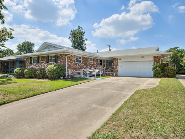 ranch-style house with a garage and a front yard