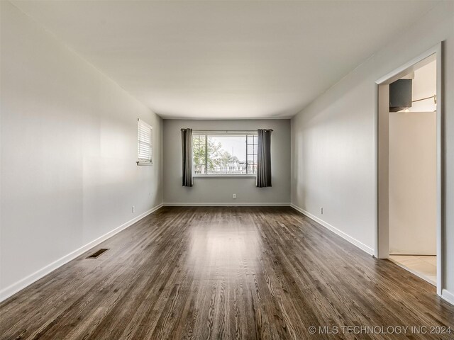 empty room with dark wood-type flooring