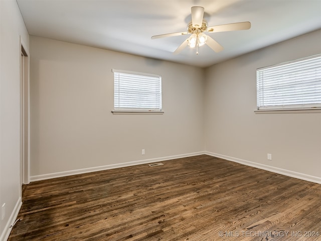 spare room featuring ceiling fan, dark hardwood / wood-style flooring, and a wealth of natural light