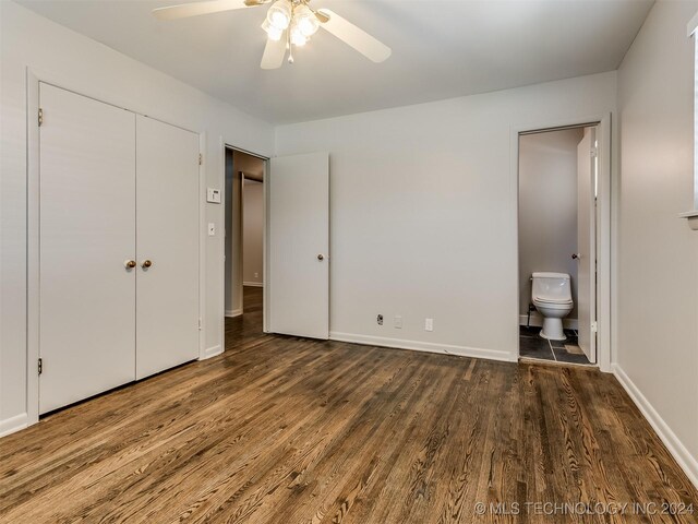 unfurnished bedroom with ensuite bathroom, ceiling fan, and dark hardwood / wood-style floors