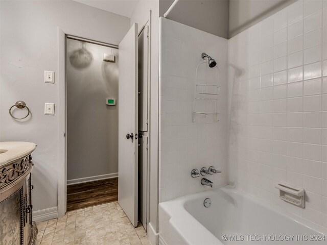 bathroom with vanity and bathtub / shower combination