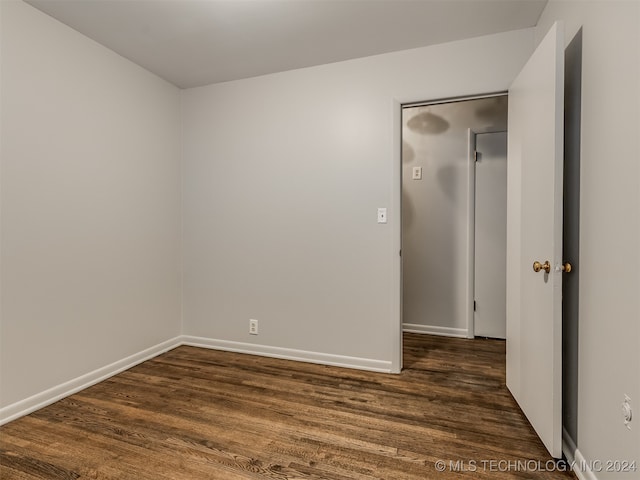 spare room with dark wood-type flooring