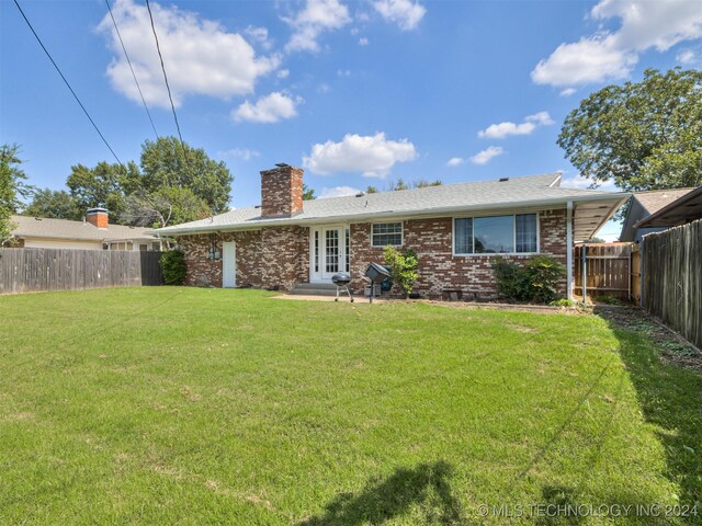 rear view of property with a yard and french doors